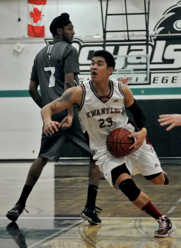 Kwantlen Eagles point guard Chris Arcangel slices past Douglas Royals forward Harpreet Randhawa during their 81-56 loss Saturday night in New Westminster. Arcangel led all Eagles in scoring last night with 14 points, and added seven rebounds and five steals.
